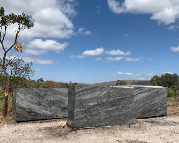 A large stone blocks in a field
Description automatically generated
