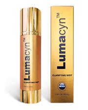 A gold tube with a gold label
Description automatically generated